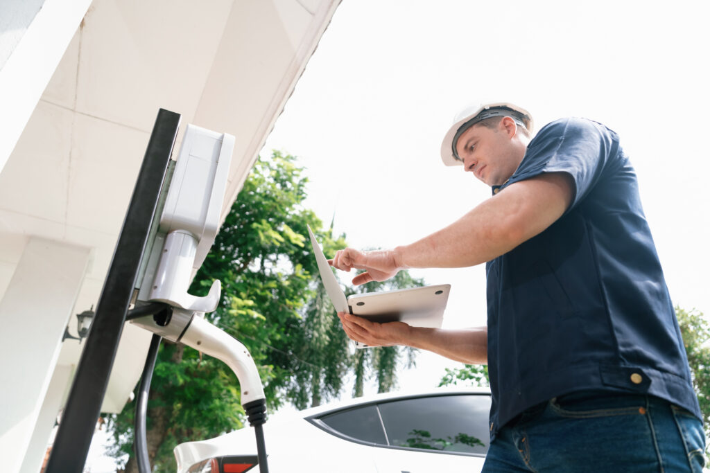 A technician works on a home EV charging station for load-management-for-ev-charging blog.